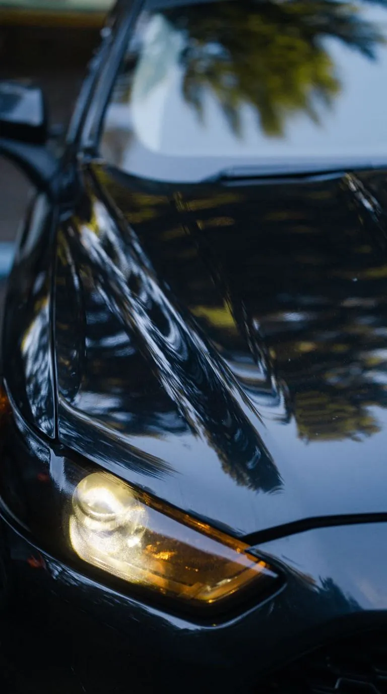 The same car in the same frame, polished, the reflections sharp again