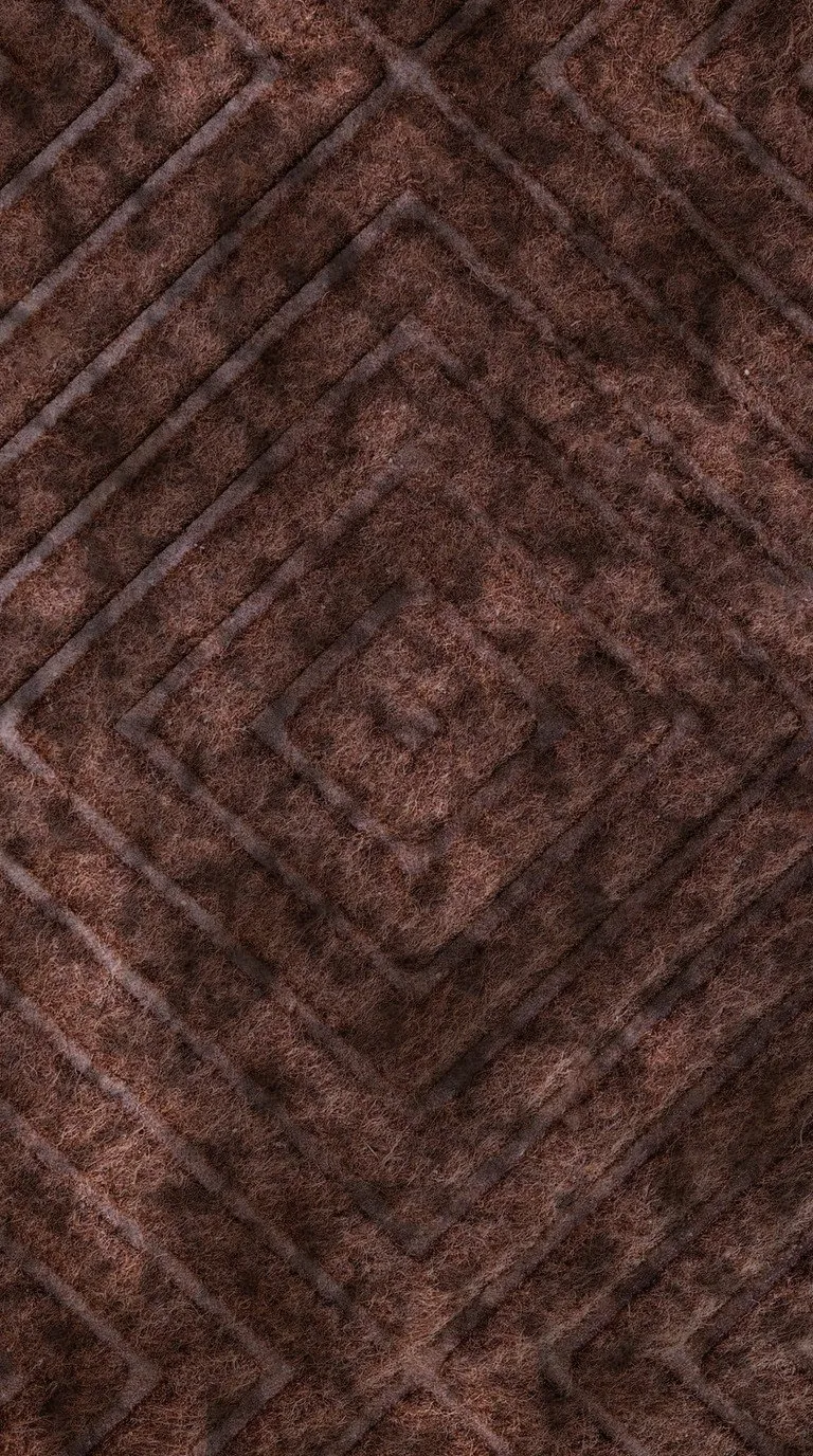 Patterned carpet pile stained in patches and dulled to a flat brown